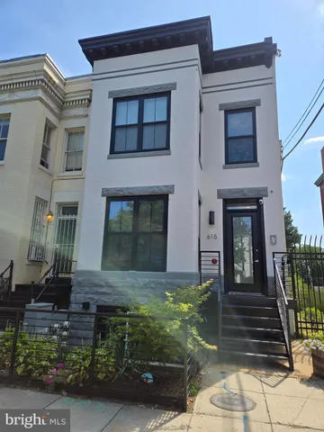 a view of a house with more windows and brick walls