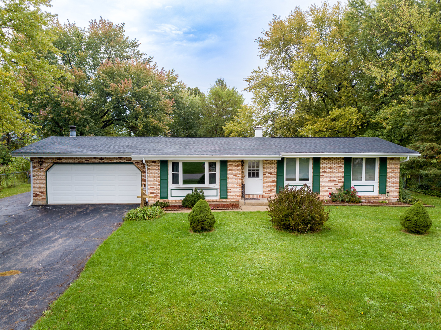 8010 Kasson Road Harvard, IL 60033 - Photo 2 of 40 a front view of a house with garden