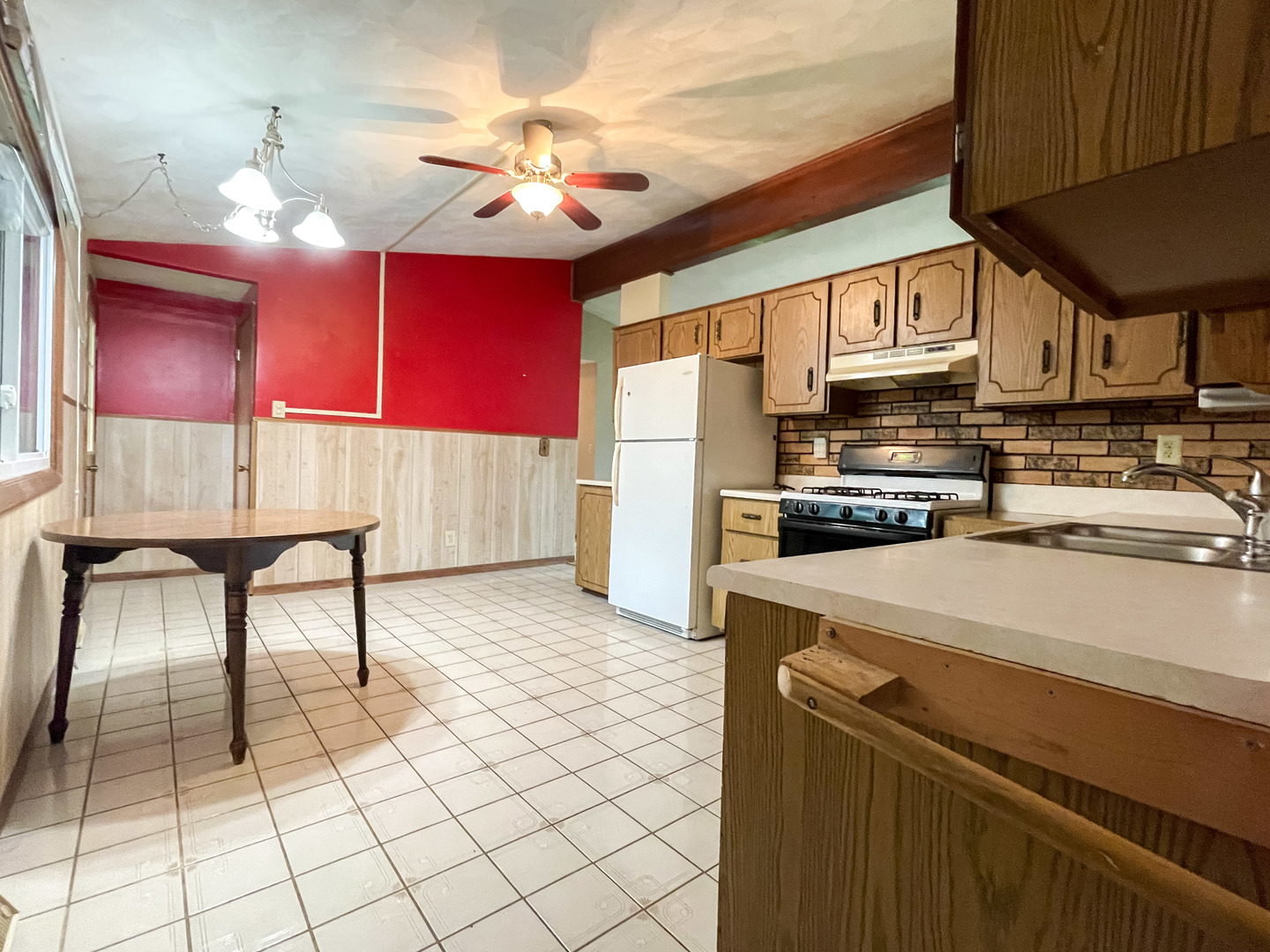 8010 Kasson Road Harvard, IL 60033 - Photo 7 of 40 a kitchen with stainless steel appliances granite countertop a sink and a refrigerator