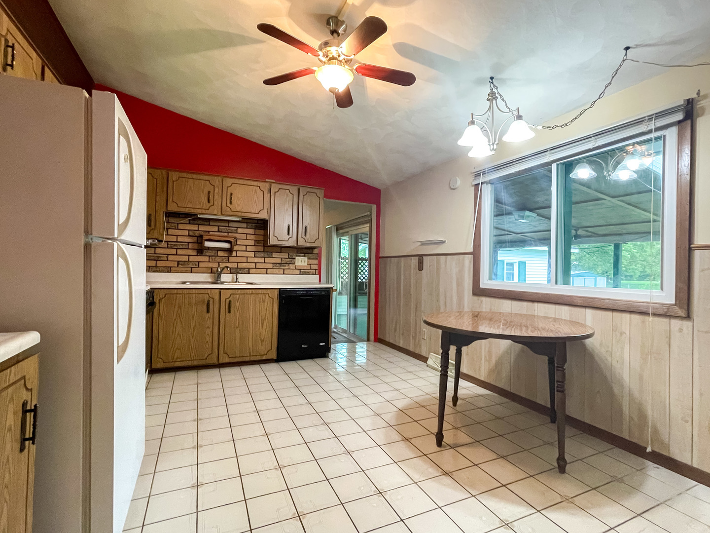 8010 Kasson Road Harvard, IL 60033 - Photo 10 of 40 a kitchen with kitchen island a stove a sink cabinetry and a chandelier
