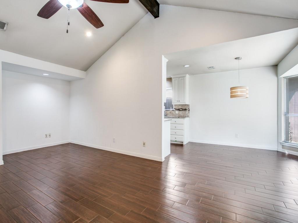 209 Ginger Lane Euless, TX 76039 - Photo 10 of 25 an empty room with wooden floor a ceiling fan and windows