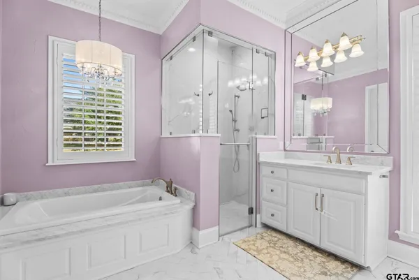 a spacious bathroom with a granite countertop tub sink and mirror