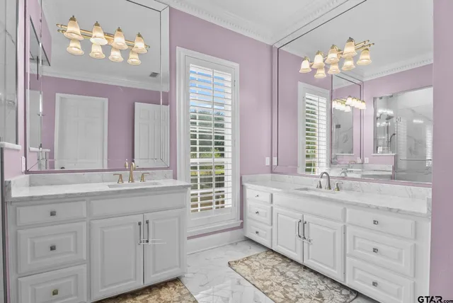 a bathroom with a sink mirror and a bathtub next to a window