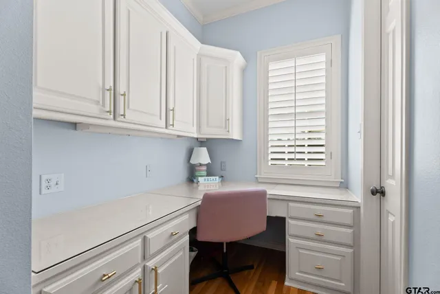 a kitchen with a white cabinets furniture and a window