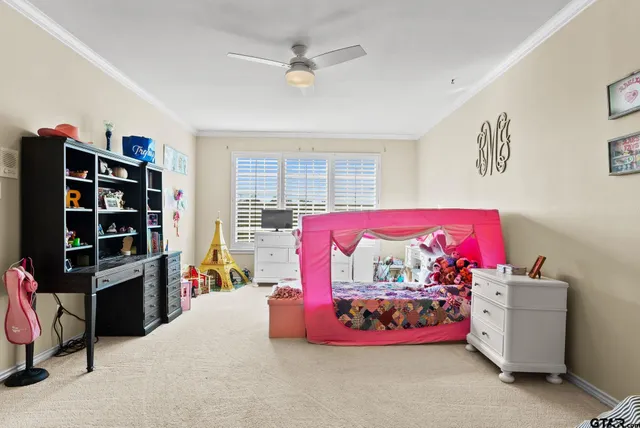 a bedroom with bed and a chandelier