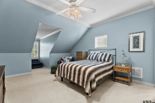 a bed room with bed and a chandelier