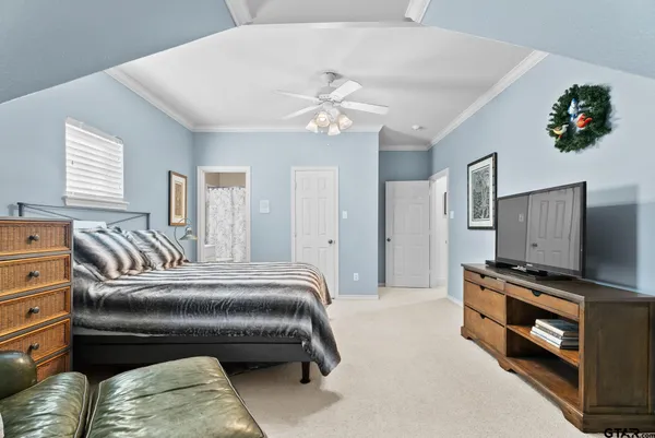 a bedroom with a bed and a television