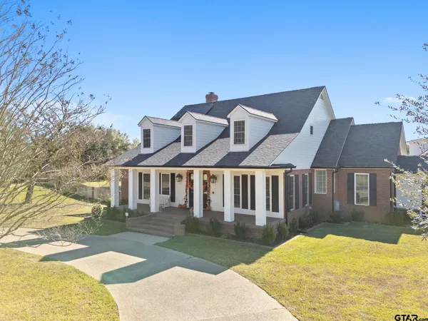 a view of a white house with a yard