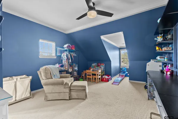 a living room with furniture a baby crib and a couch