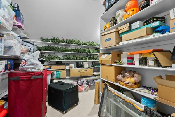 a utility room with lots of clutter and cabinets