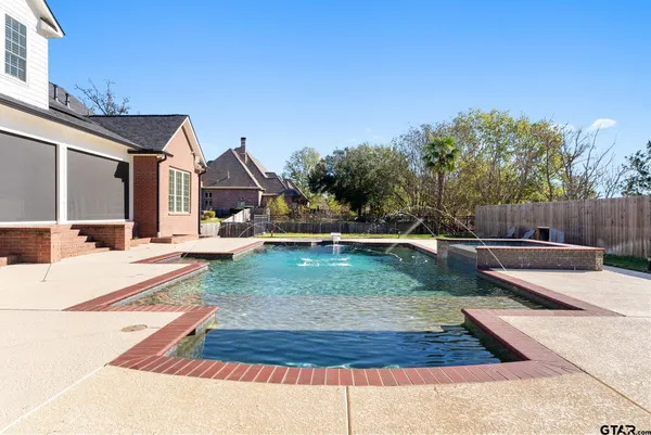 a view of a house with swimming pool and sitting area