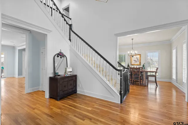 a view of entryway and hall with wooden floor