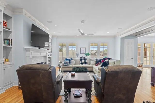 a living room with fireplace furniture and a flat screen tv