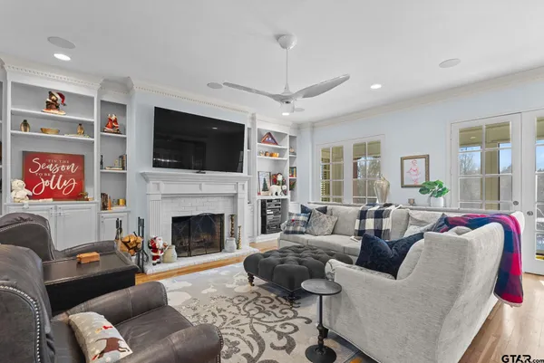 a living room with furniture a flat screen tv and a fireplace