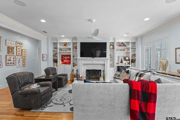 a living room with furniture fireplace and flat screen tv