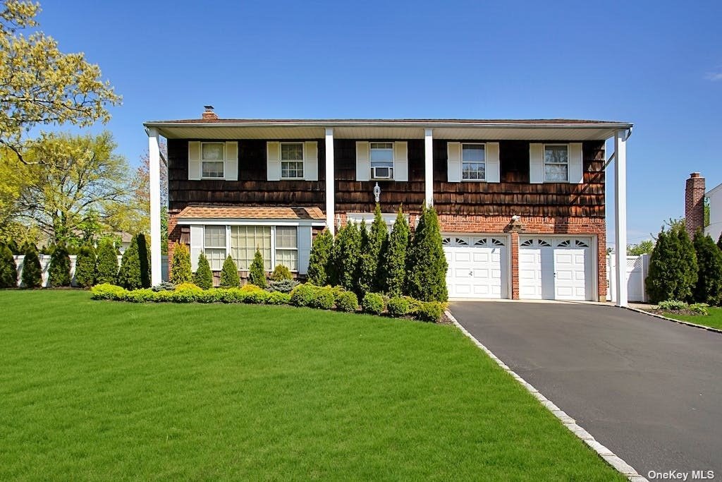 a front view of house with yard and green space