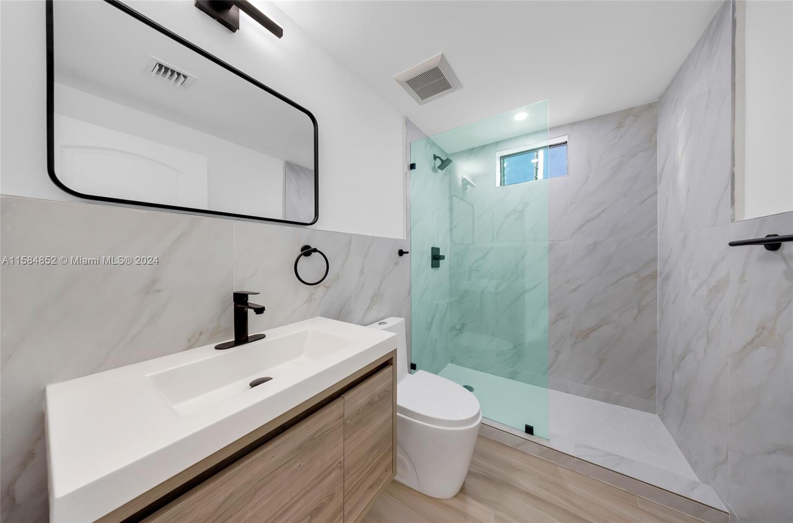 1335 Southwest 4th Street Miami, FL 33135 - Photo 16 of 59 a bathroom with a sink a toilet and shower