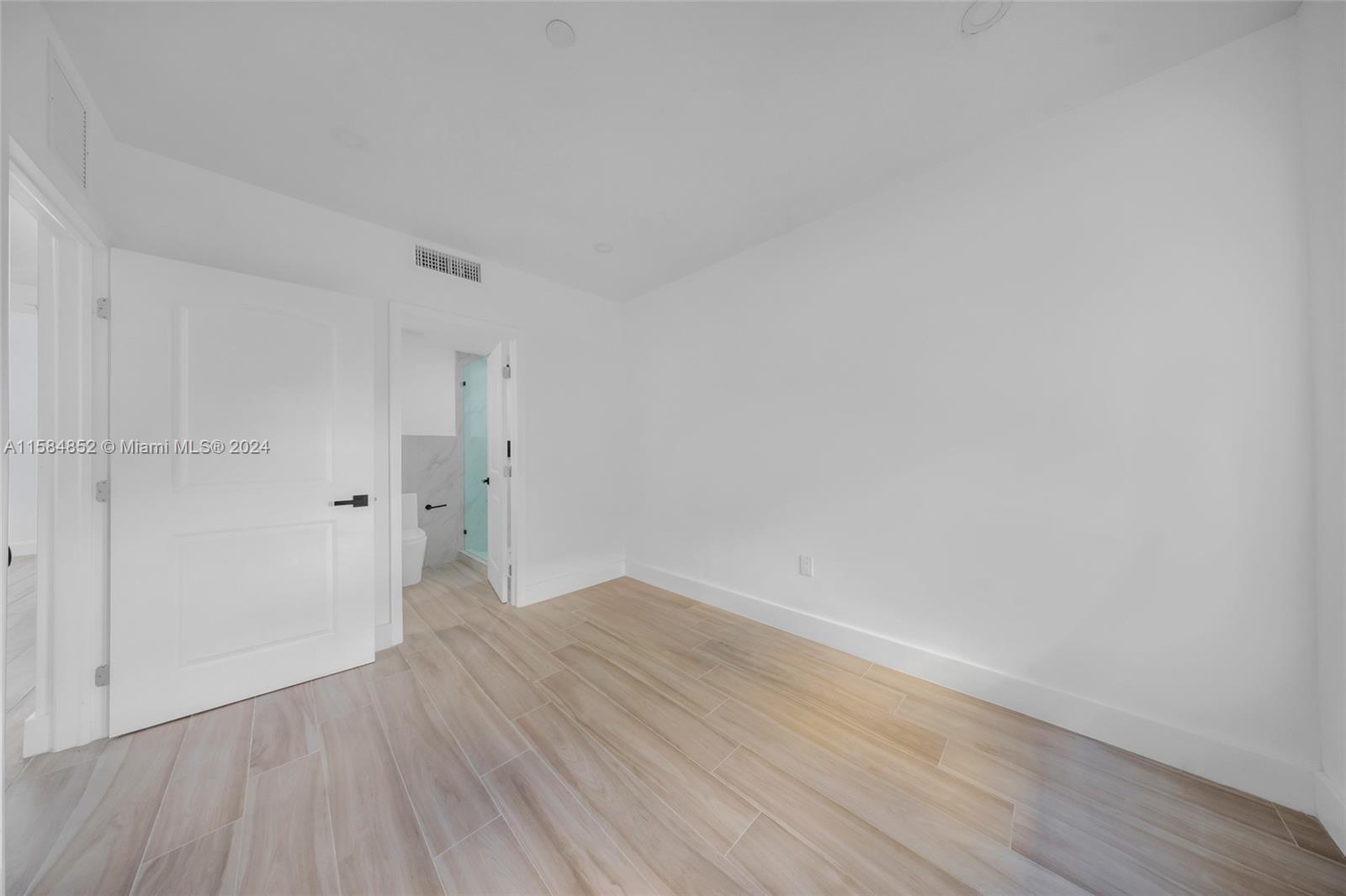 1335 Southwest 4th Street Miami, FL 33135 - Photo 18 of 59 a view of an empty room with wooden floor