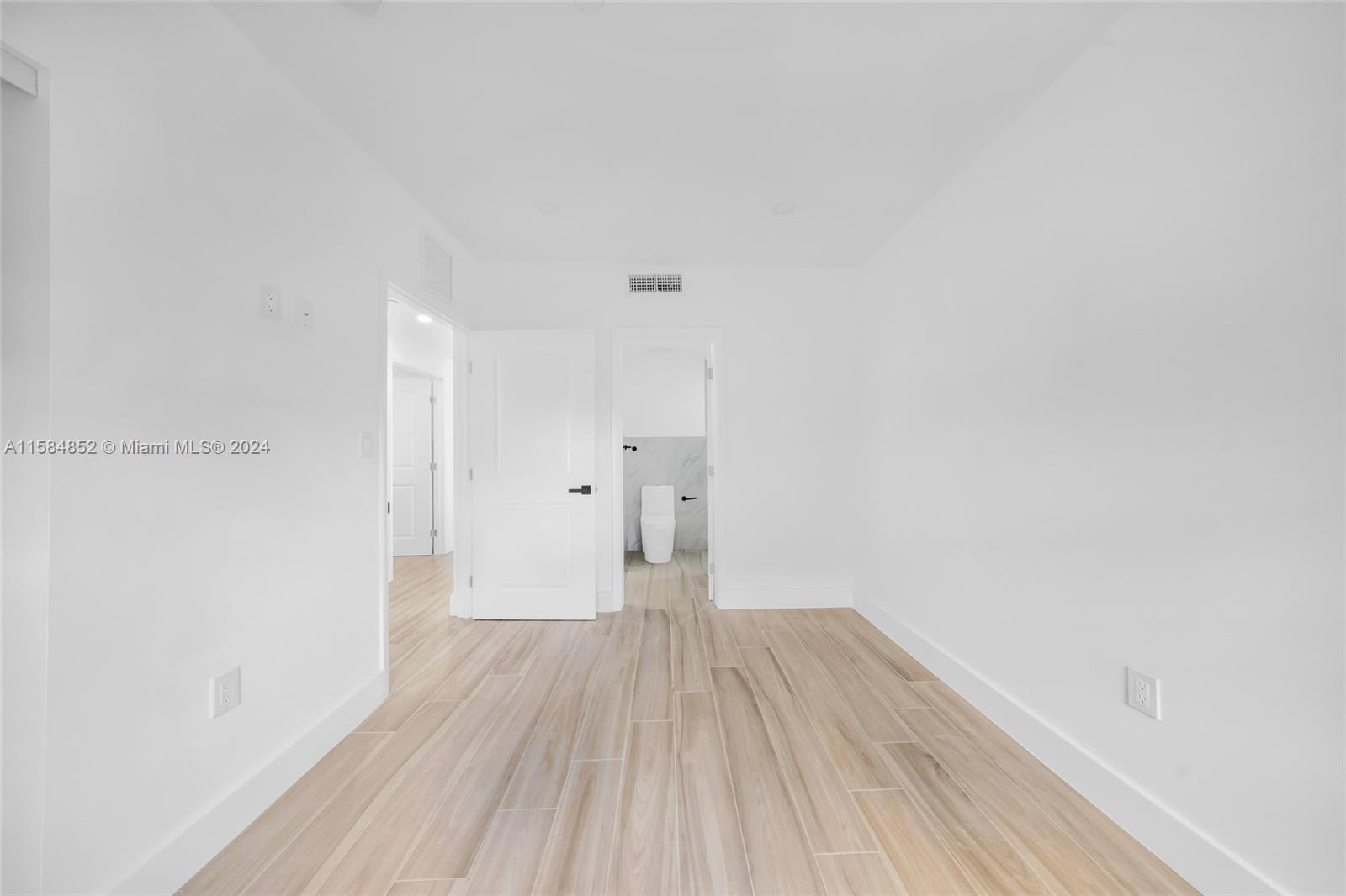 1335 Southwest 4th Street Miami, FL 33135 - Photo 19 of 59 a view of a room with wooden floor and a ceiling fan