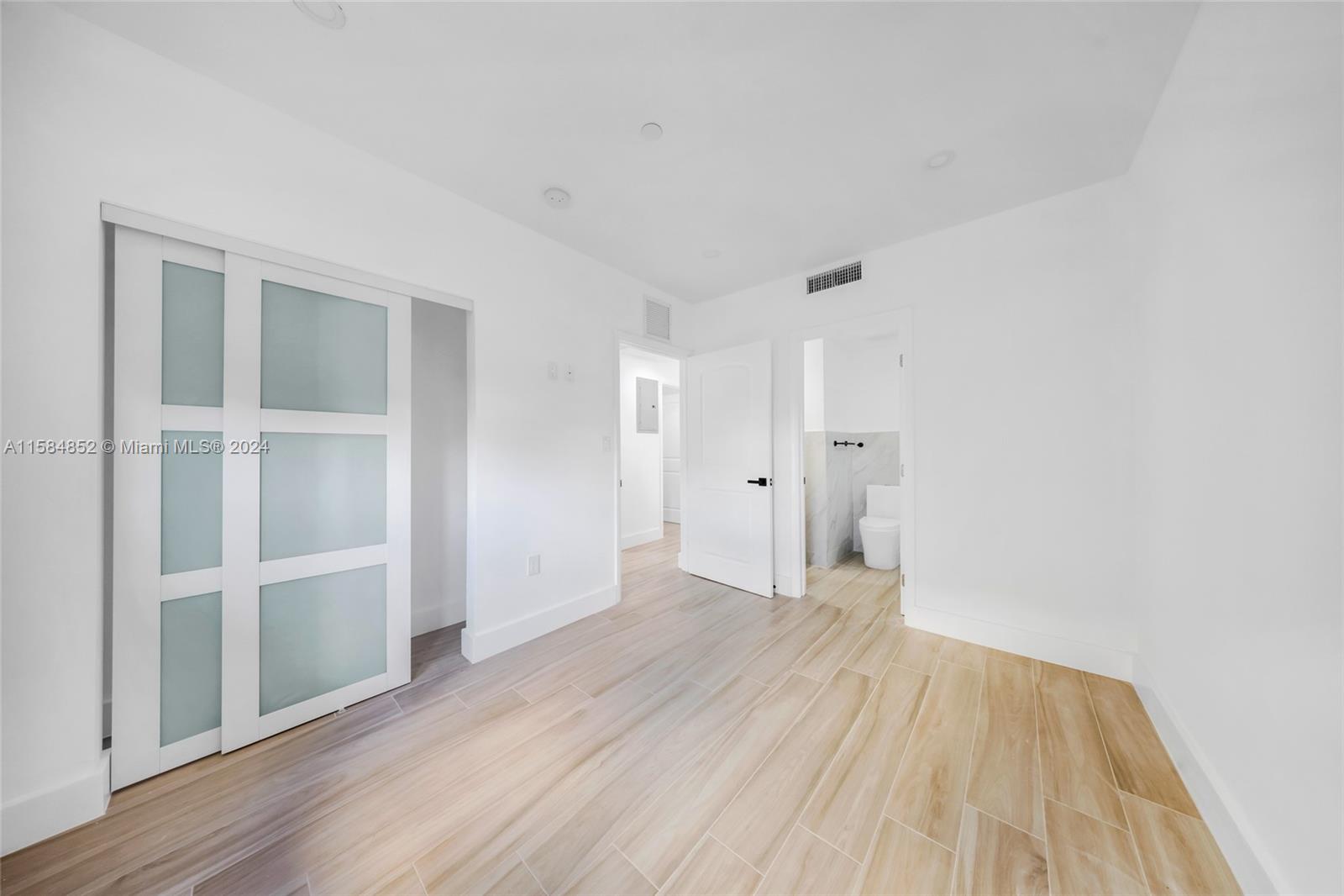 1335 Southwest 4th Street Miami, FL 33135 - Photo 20 of 59 a view of an empty room with wooden floor and closet