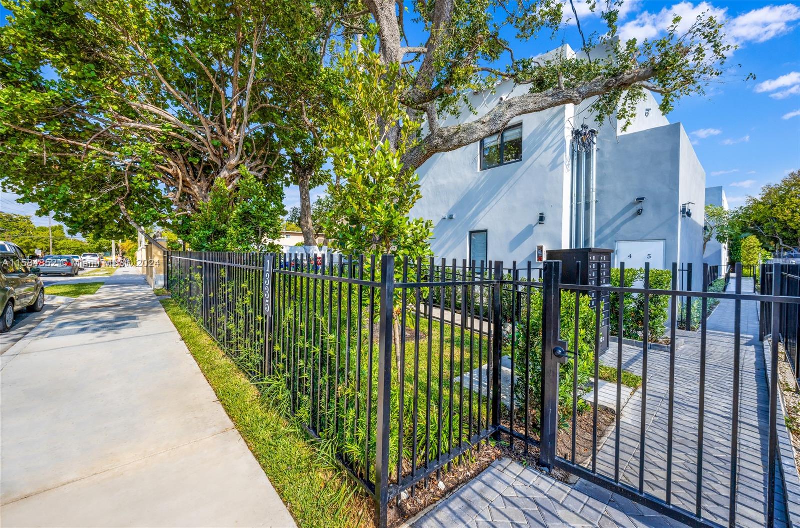 1335 Southwest 4th Street Miami, FL 33135 - Photo 27 of 59 a view of a house with a small yard and large trees