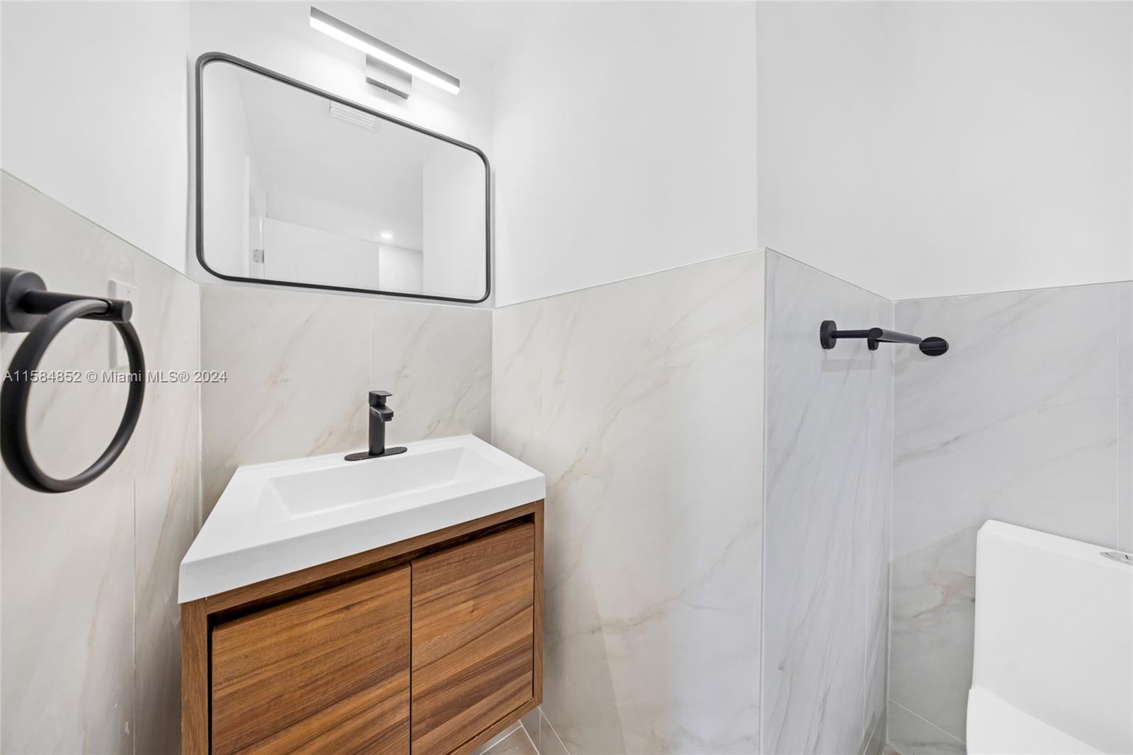 1335 Southwest 4th Street Miami, FL 33135 - Photo 28 of 59 a bathroom with a sink a vanity and a mirror