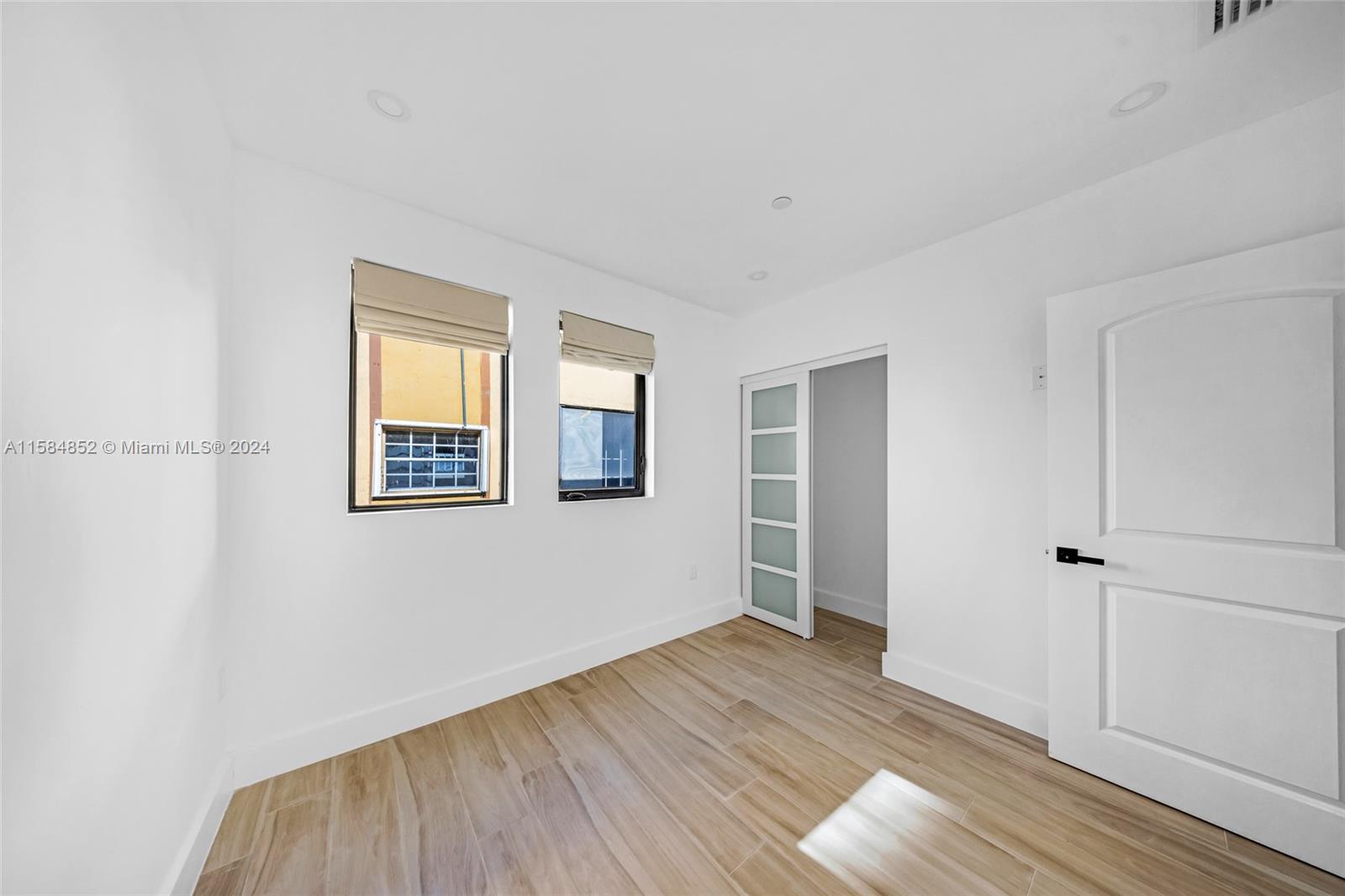 1335 Southwest 4th Street Miami, FL 33135 - Photo 41 of 59 a view of an empty room with wooden floor and a window
