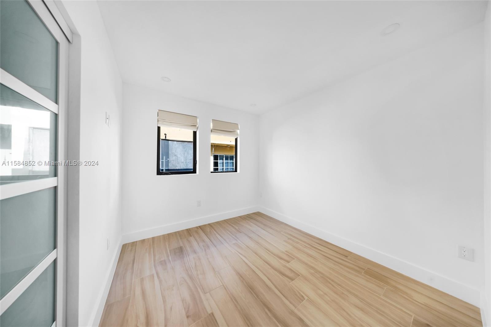 1335 Southwest 4th Street Miami, FL 33135 - Photo 43 of 59 a view of an empty room with wooden floor and a window