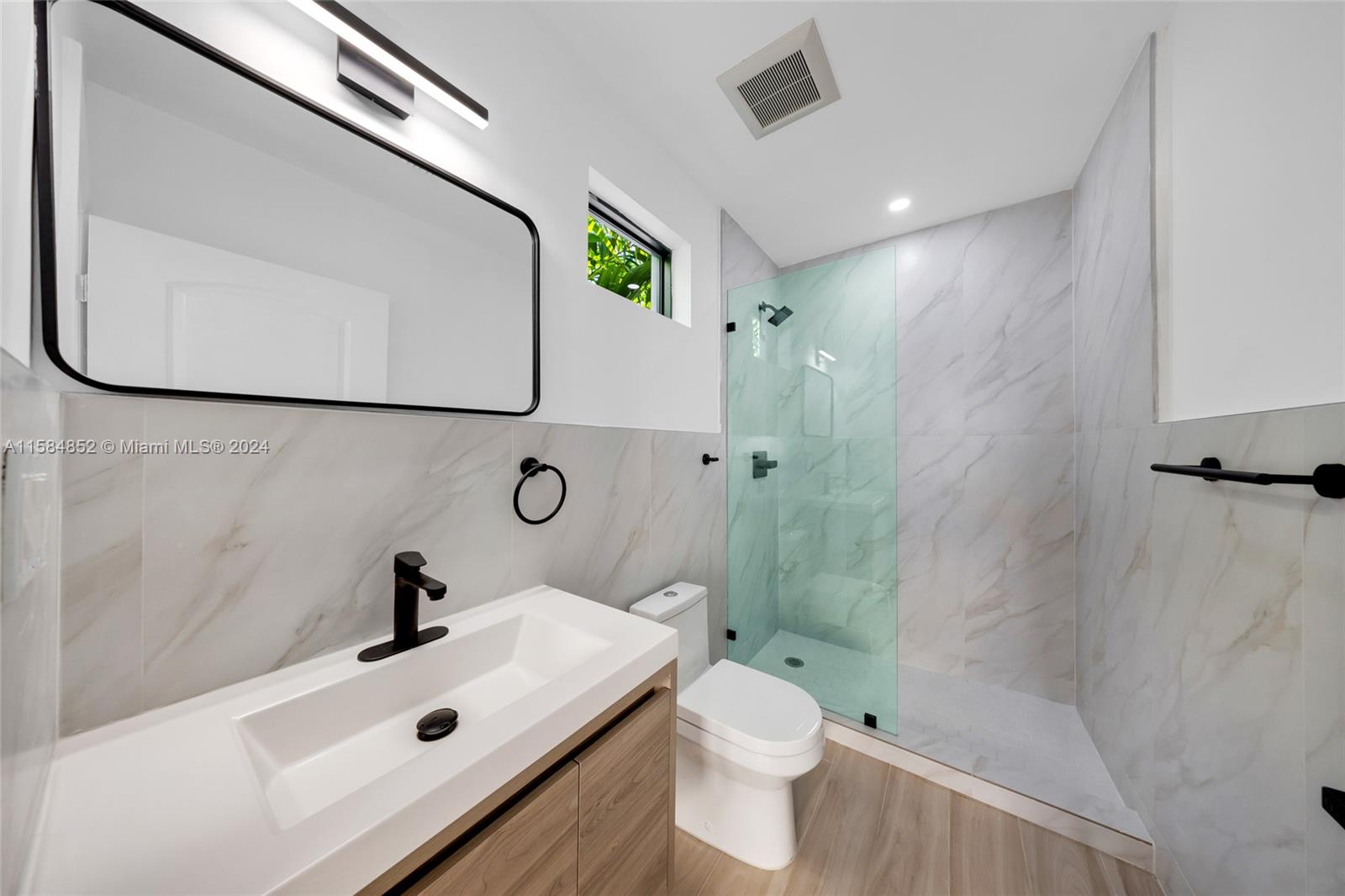 1335 Southwest 4th Street Miami, FL 33135 - Photo 45 of 59 a bathroom with a sink a toilet and shower