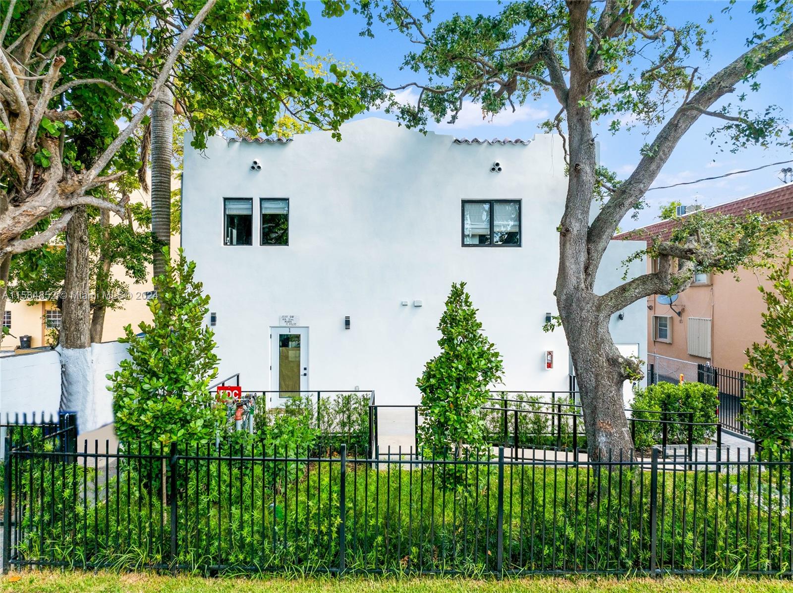 1335 Southwest 4th Street Miami, FL 33135 - Photo 5 of 59 a front view of a house with a garden