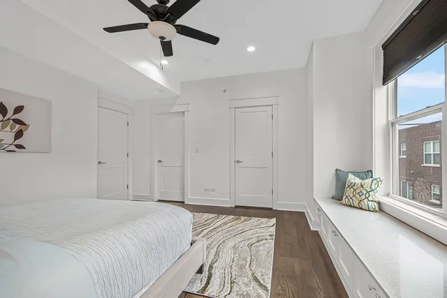 a bedroom with a large bed and a large window