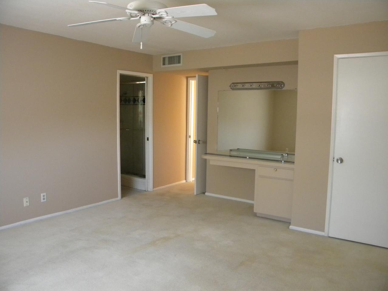 2964 East Bloomfield Road Phoenix, AZ 85032 - Photo 7 of 10 an empty room with chandelier fan and kitchen view