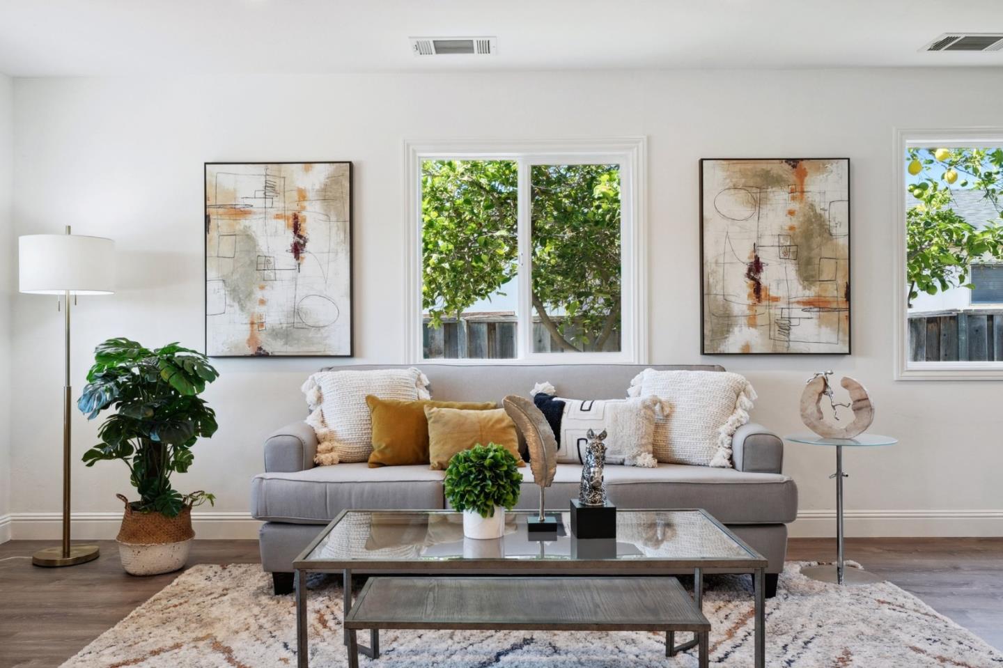 a living room with furniture and a potted plant