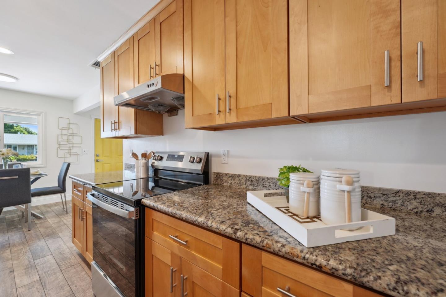 4615 Armour Drive Santa Clara, CA 95054 - Photo 10 of 35 a kitchen with kitchen island granite countertop a sink a stove and cabinets