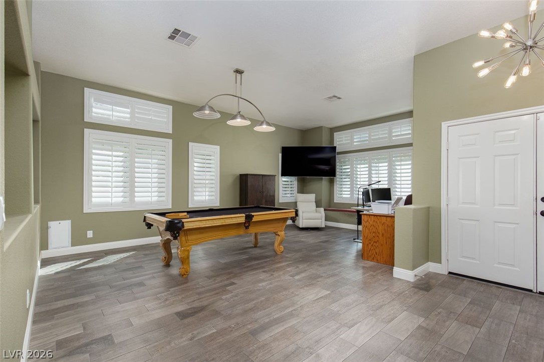 4670 Los Rancheros Avenue Las Vegas, NV 89129 - Photo 13 of 57 Gleaming wood-look tile floors and classic plantation shutters define this versatile recreational space.