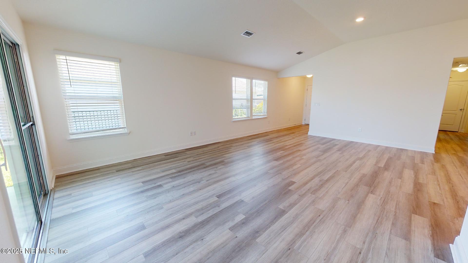 408 Bluejack Lane St. Augustine, FL 32095 - Photo 19 of 30 an empty room with wooden floor and windows