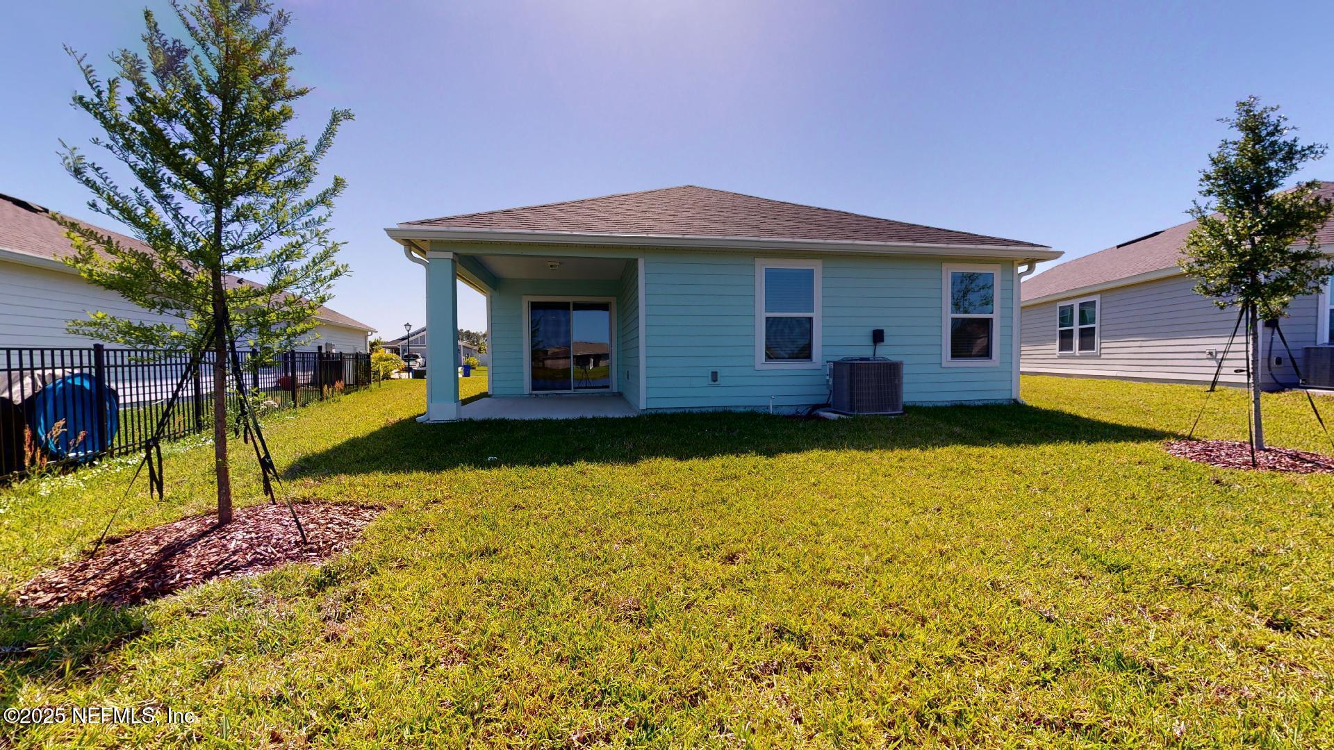 408 Bluejack Lane St. Augustine, FL 32095 - Photo 2 of 30 a view of a house with swimming pool next to a yard