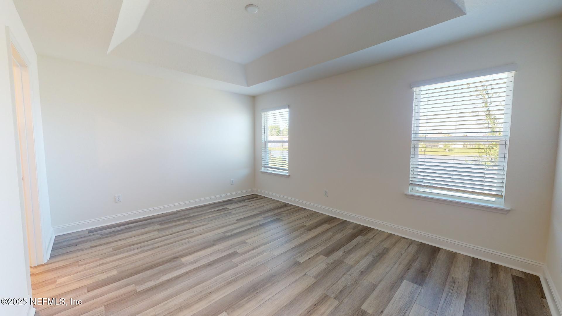 408 Bluejack Lane St. Augustine, FL 32095 - Photo 22 of 30 an empty room with wooden floor and windows