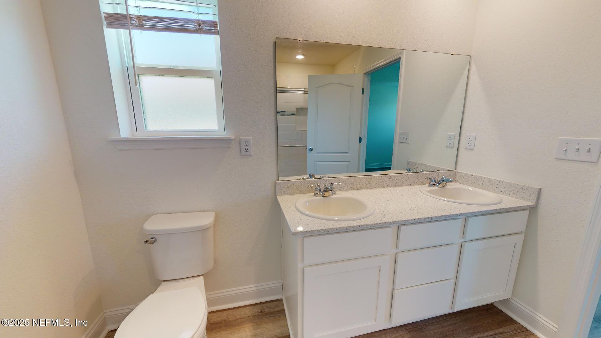 408 Bluejack Lane St. Augustine, FL 32095 - Photo 26 of 30 a bathroom with a toilet sink and mirror