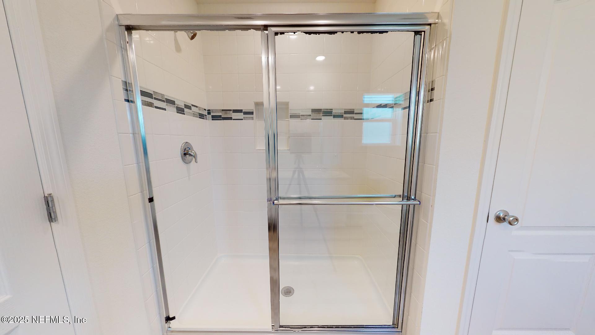 408 Bluejack Lane St. Augustine, FL 32095 - Photo 27 of 30 a bathroom with a glass shower door