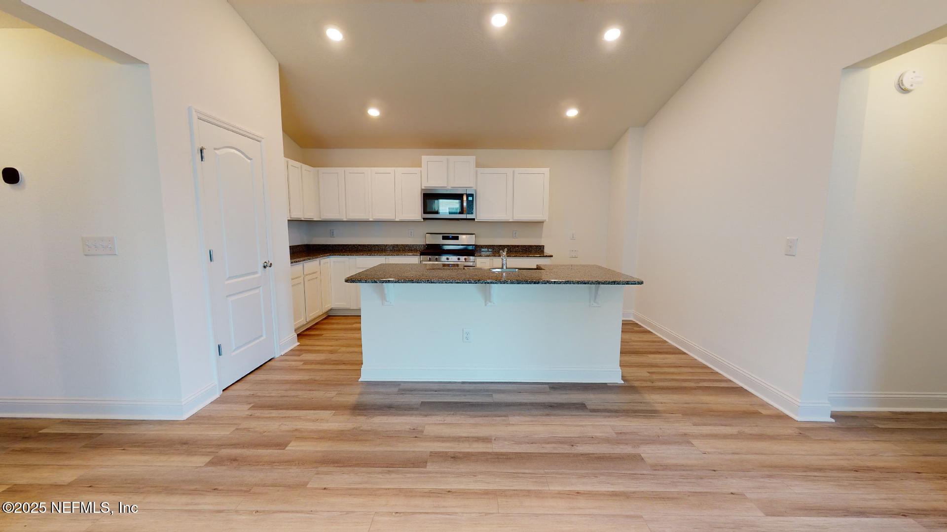408 Bluejack Lane St. Augustine, FL 32095 - Photo 5 of 30 a view of kitchen with wooden floor