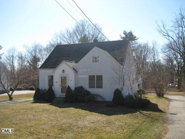 a view of house with yard covered in snow