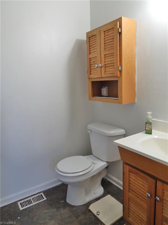 1048 State Line Church Road Westfield, NC 27053 - Photo 14 of 29 Hall bathroom has single vanity, tub/shower combo and storage cabinet located on other side of the wall. The laundry shoot in the floor!