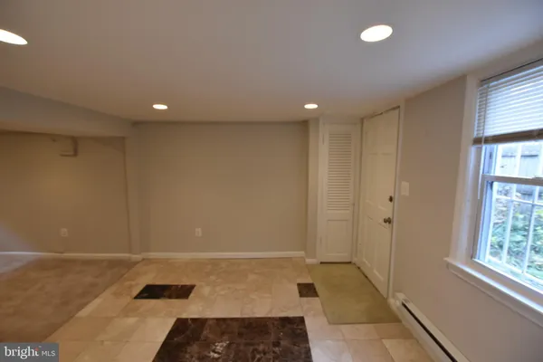 a view of hallway with a rug and a window