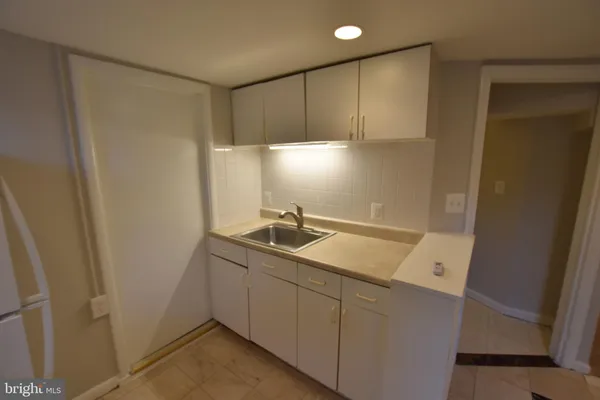 a utility room with cabinets washer and dryer