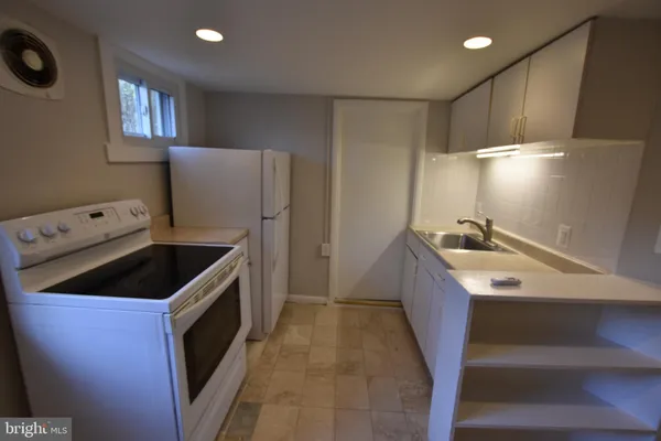 a kitchen that has a sink and a stove in it