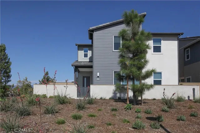 a view of a house with a yard and plants