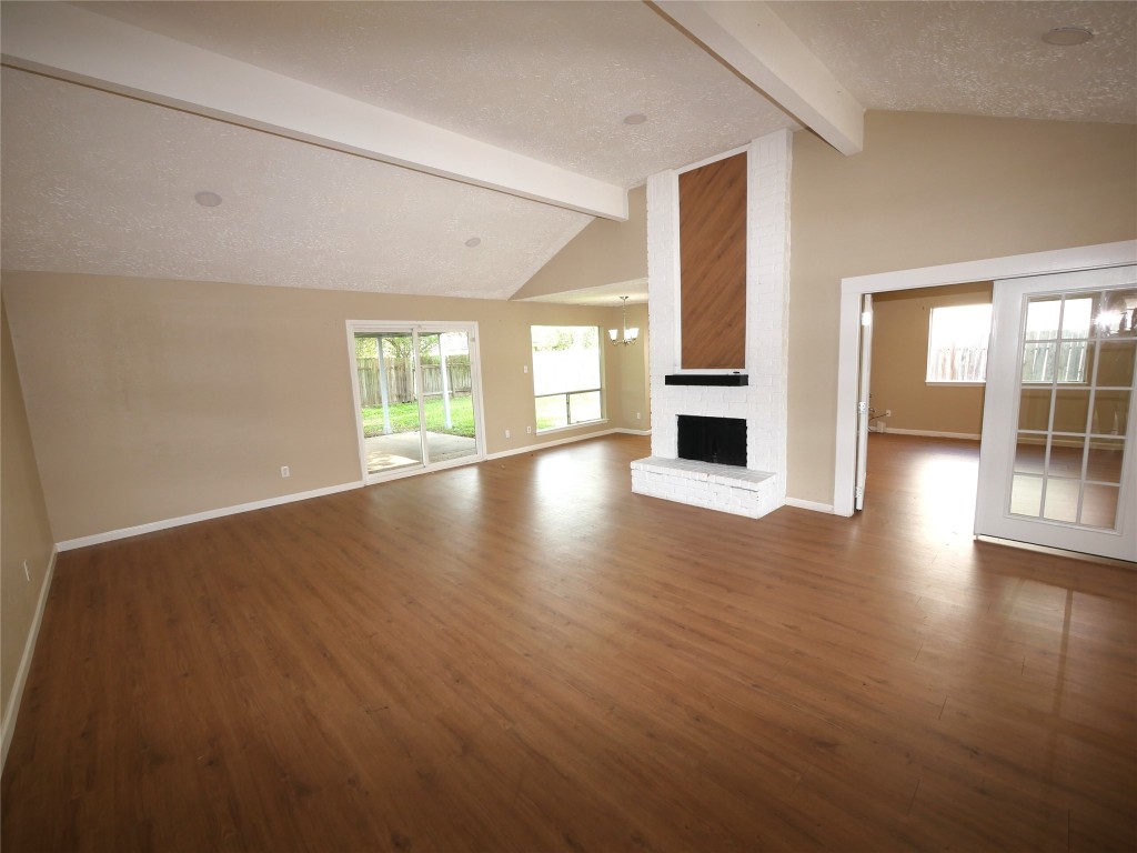 6826 Addicks Clodine Road Houston, TX 77083 - Photo 3 of 12 Huge family room with high ceilings, wood-burning fireplace, and plenty of natural light. Perfect for gatherings or relaxing.