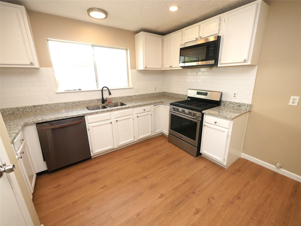6826 Addicks Clodine Road Houston, TX 77083 - Photo 6 of 12 Modern, open kitchen with new appliances, ample cabinets, and breakfast/dining connection.