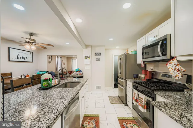 a kitchen with counter top space cabinets and stainless steel appliances